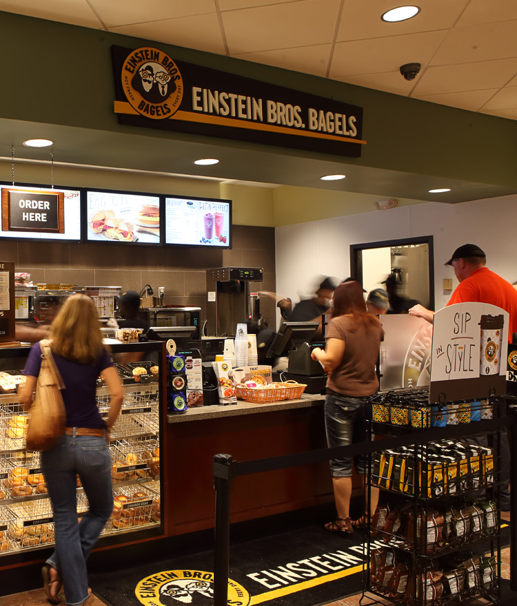 People waiting in line at Einstein Bagels